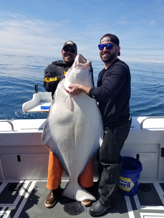 halibut-charters-homer-alaska-3 happy angler with his large halibut in homer alaska